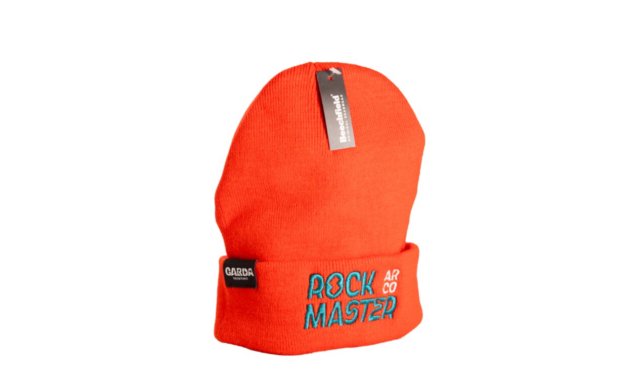 An orange cap with the embroidered text "ROCK MASTER." It is a fashionable accessory perfect for winter.