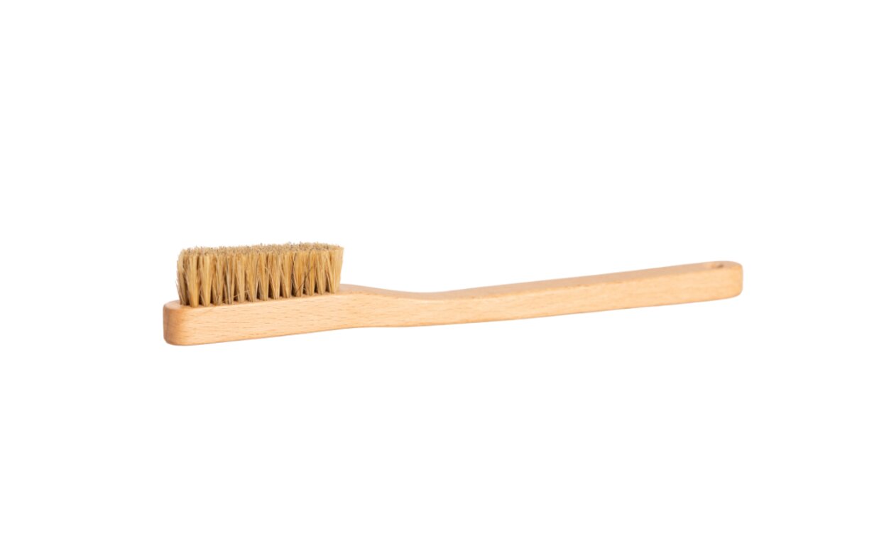A wooden brush with natural bristles. It is simple and eco-friendly, suitable for daily care.
